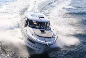 Slide: The Image of 2022 Jeanneau NC 1095 motorboat cruising on water. - 8