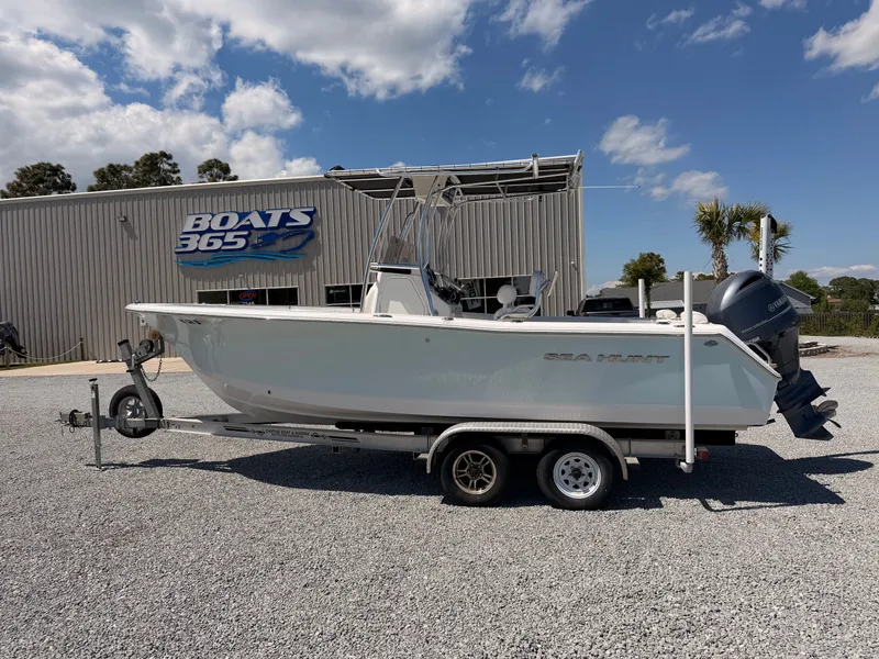The Image of 2016 Sea Hunt Triton 225 boat on trailer in front of boat building. - 0