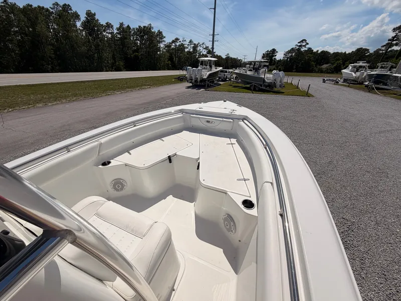 Slide: The Image of Interior view of a 2016 Sea Hunt Triton 225 boat in a parking area. - 10