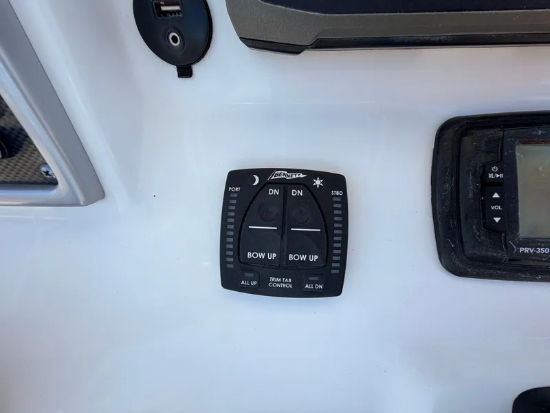 Slide: The Image of Trim tab control on Sea Hunt Triton 225 boat. - 15