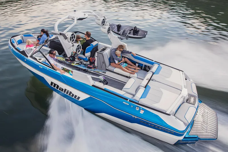 Slide: The Image of Manufacturer Provided Image: 2019 Malibu Wakesetter 25 LSV boat cruising with passengers on a lake. - 7