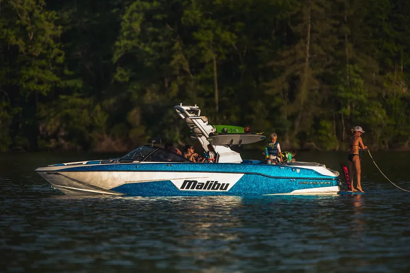 Slide: The Image of Manufacturer Provided Image: 2019 Malibu Wakesetter 25 LSV on a lake with people enjoying water activities. - 8