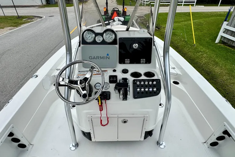 Slide: The Image of 2021 NauticStar 227 XTS boat console with Garmin navigation and steering wheel. - 10