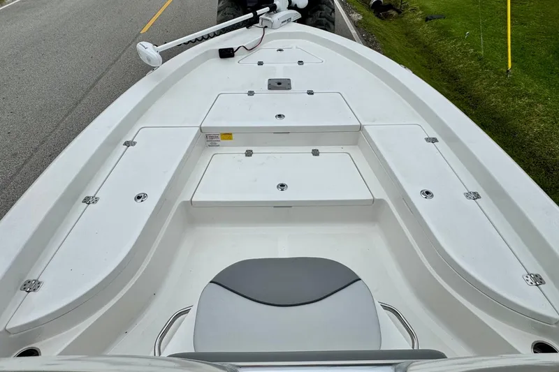 Slide: The Image of 2021 NauticStar 227 XTS boat deck with storage compartments and seating. - 13
