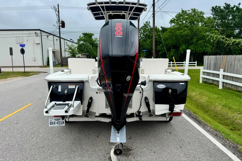 Slide: The Image of 2021 NauticStar 227 XTS boat with powerful outboard motor on a street. - 3