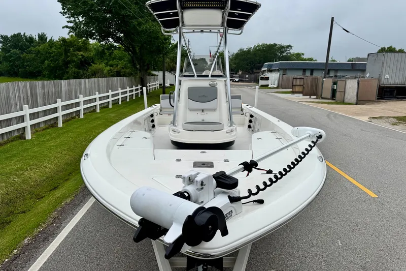 Slide: The Image of 2021 NauticStar 227 XTS boat with trolling motor on a suburban street. - 6