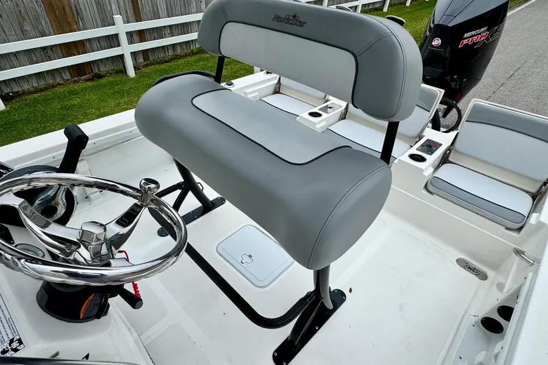 Slide: The Image of 2021 NauticStar 227 XTS boat interior with steering wheel and seating. - 9