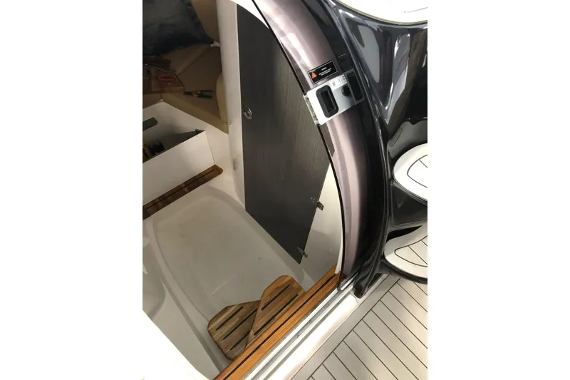 Slide: The Image of 2024 Hanover 305 boat interior with sleek design and wooden accents. - 12