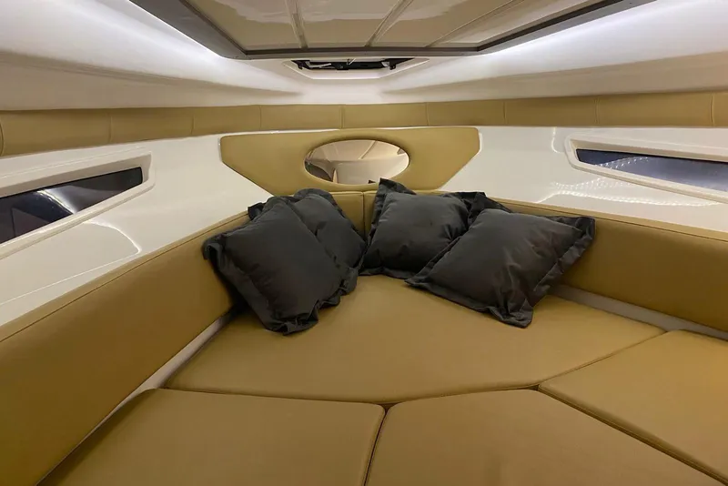 Slide: The Image of Luxurious interior of 2024 Hanover 305 boat with plush seating and cushions. - 16