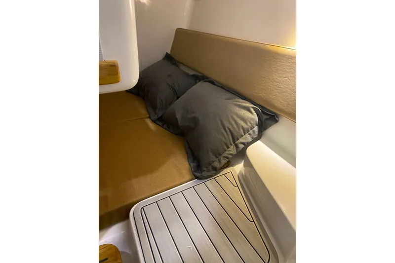 Slide: The Image of 2024 Hanover 305 cabin interior with cozy bedding and wooden accents. - 17