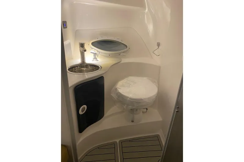 Slide: The Image of Compact bathroom in 2024 Hanover 305 boat with sink, toilet, and porthole window. - 18