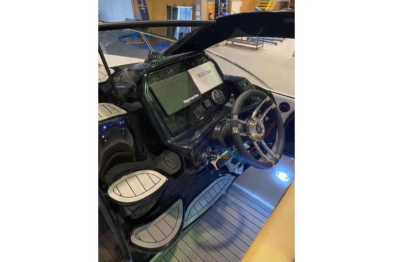 Slide: The Image of 2024 Hanover 305 boat cockpit with modern steering and navigation system. - 20
