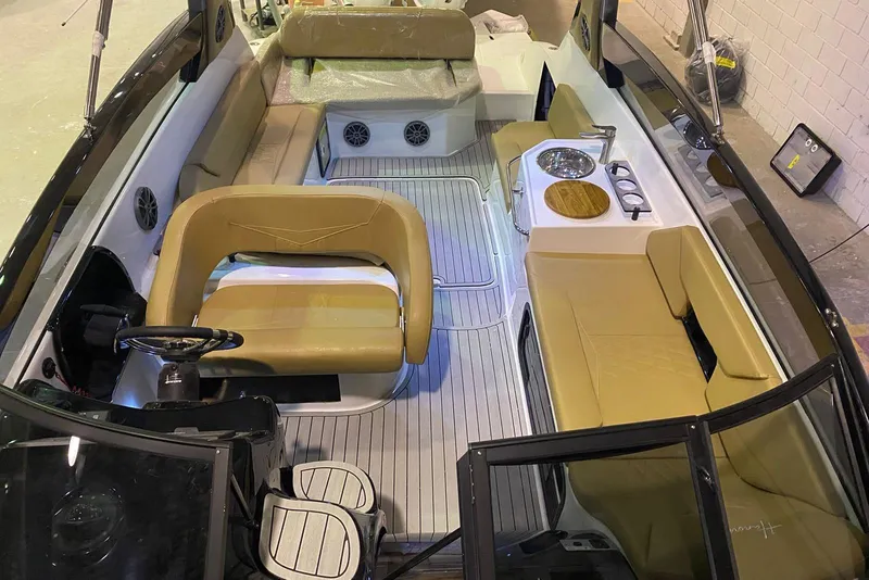 Slide: The Image of Interior of 2024 Hanover 305 boat with tan seating and modern amenities. - 21