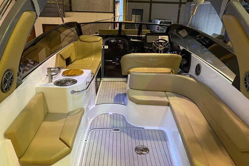 Slide: The Image of Luxurious interior of 2024 Hanover 305 boat with beige seating and modern amenities. - 22