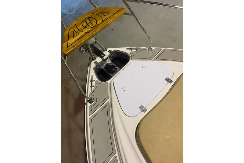 Slide: The Image of 2024 Hanover 305 boat deck with wooden accents and stainless steel fittings. - 23