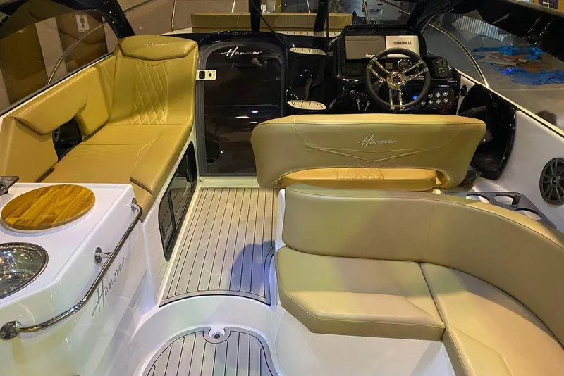 Slide: The Image of Luxurious interior of 2024 Hanover 305 boat with beige seating and modern dashboard. - 24