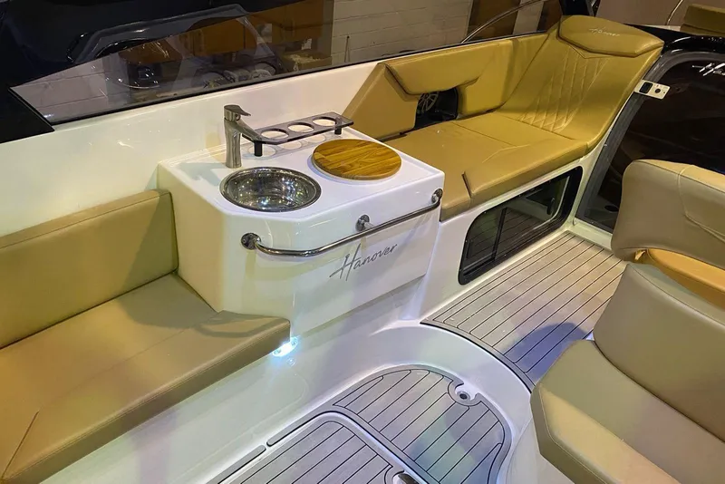 Slide: The Image of Luxurious interior of 2024 Hanover 305 boat with beige seating and modern amenities. - 25