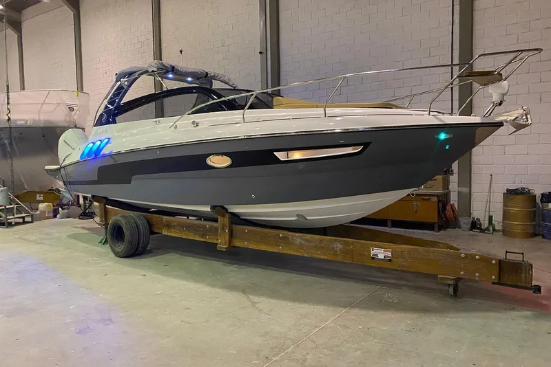 Slide: The Image of 2024 Hanover 305 boat in a warehouse, showcasing sleek design and modern features. - 5