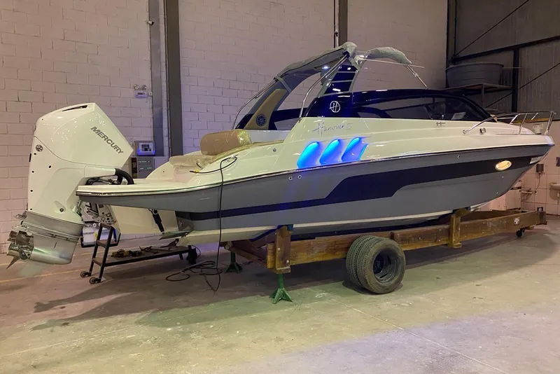 Slide: The Image of 2024 Hanover 305 boat with Mercury engine in a warehouse setting. - 6