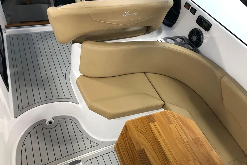 Slide: The Image of Luxurious interior of 2024 Hanover 305 boat with beige seating and wooden table. - 7