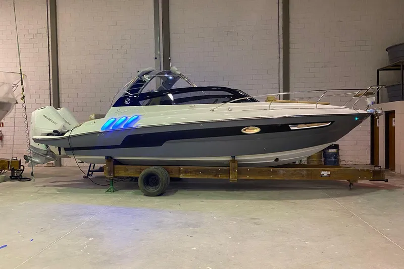 Slide: The Image of 2024 Hanover 305 boat in a warehouse, featuring sleek design and modern lighting. - 8
