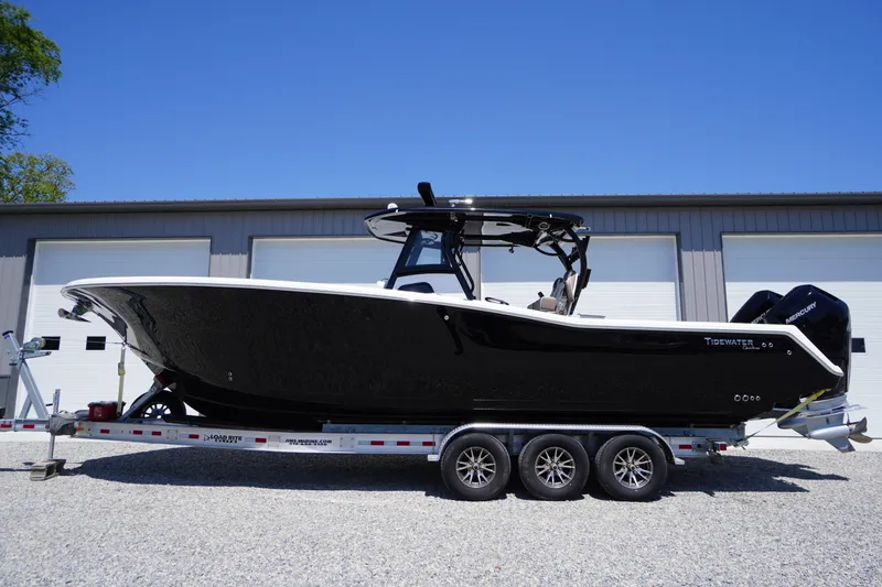 The Image of 2024 Tidewater 320 CC Adventure boat on trailer, parked outdoors. - 1