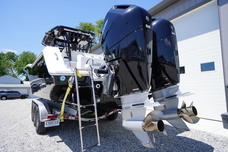 Slide: The Image of 2024 Tidewater 320 CC Adventure boat with dual Mercury outboard engines on a trailer. - 13