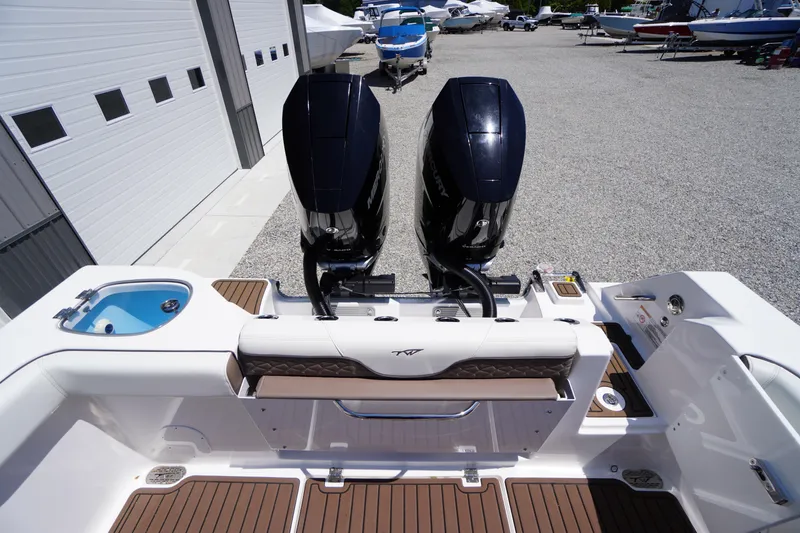 Slide: The Image of 2024 Tidewater 320 CC Adventure boat with dual outboard motors in a marina setting. - 14