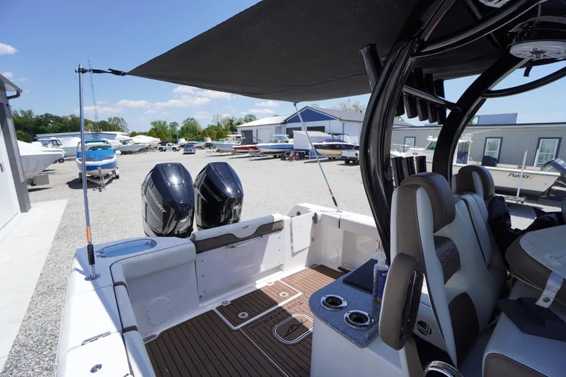 Slide: The Image of 2024 Tidewater 320 CC Adventure boat with dual Mercury engines at a marina. - 15