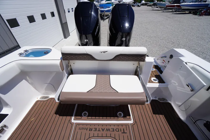 Slide: The Image of 2024 Tidewater 320 CC Adventure boat interior with seating and twin engines. - 16
