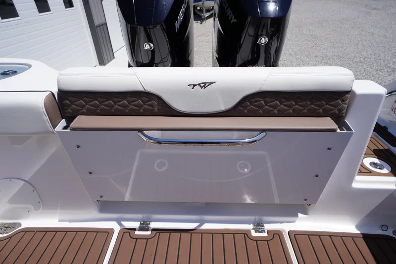 Slide: The Image of 2024 Tidewater 320 CC Adventure boat with cushioned seating and dual Mercury engines. - 17