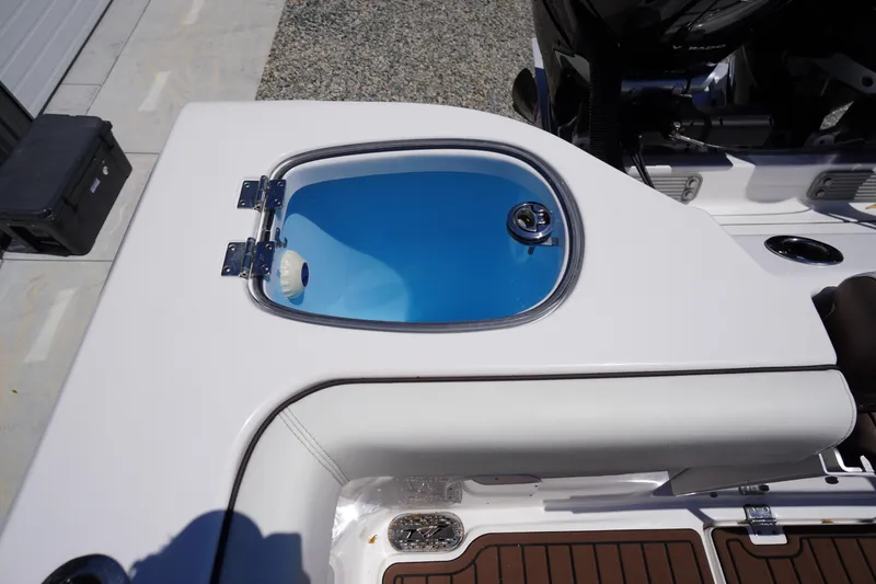 Slide: The Image of 2024 Tidewater 320 CC Adventure boat with open livewell on deck. - 19