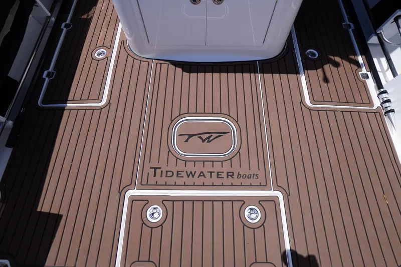 Slide: The Image of 2024 Tidewater 320 CC Adventure boat deck with logo and sleek design. - 20