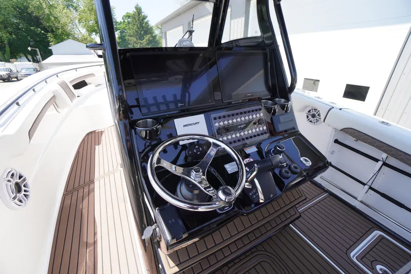 Slide: The Image of 2024 Tidewater 320 CC Adventure boat helm with modern controls and sleek design. - 27