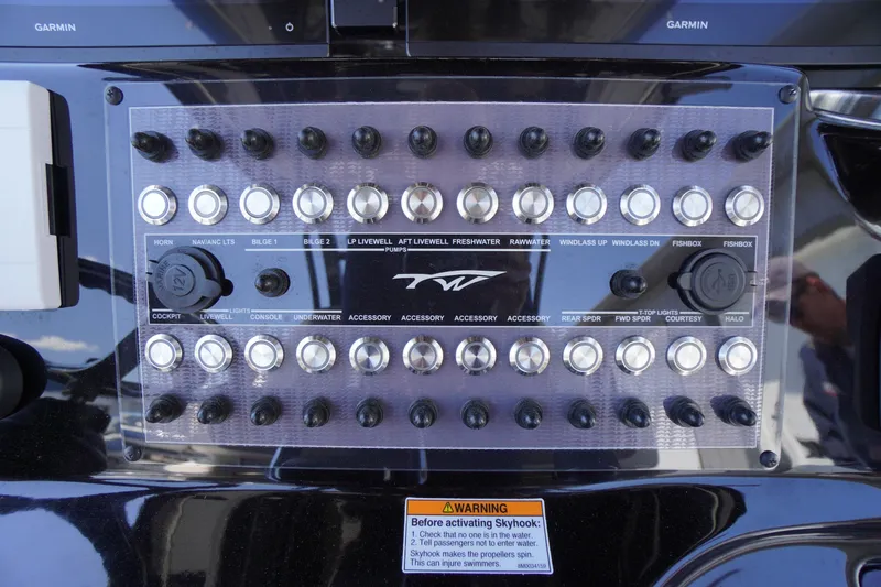 Slide: The Image of Control panel of 2024 Tidewater 320 CC Adventure boat with labeled switches and buttons. - 30