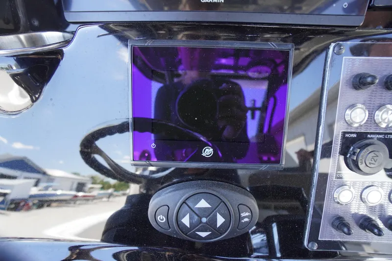 Slide: The Image of Control panel of 2024 Tidewater 320 CC Adventure boat with touchscreen and buttons. - 32