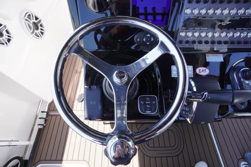 Slide: The Image of Steering wheel of 2024 Tidewater 320 CC Adventure boat, featuring modern controls and dashboard. - 34