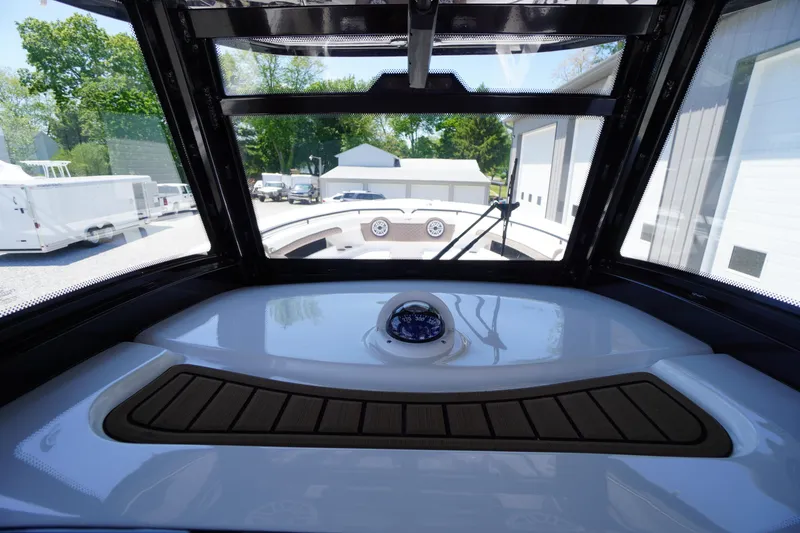 Slide: The Image of 2024 Tidewater 320 CC Adventure boat interior with compass and windshield view. - 38