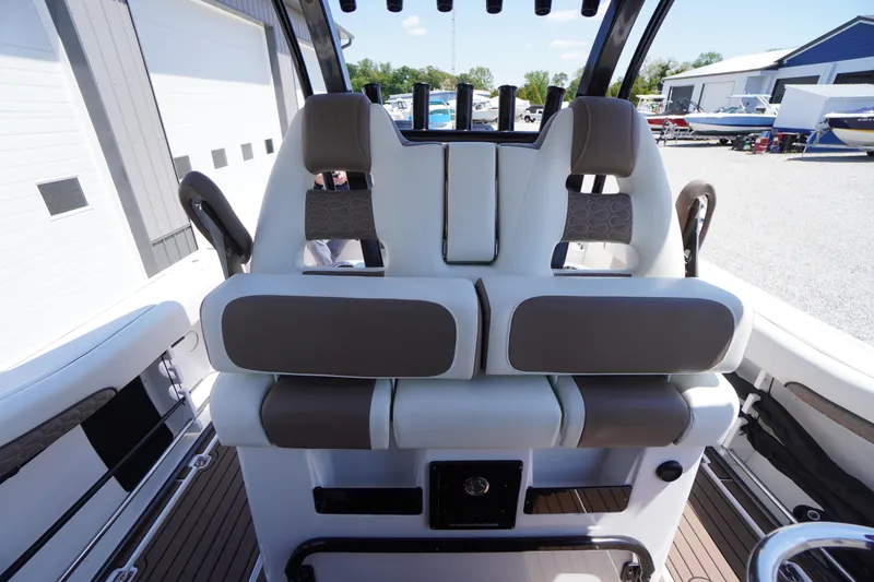 Slide: The Image of 2024 Tidewater 320 CC Adventure boat interior with dual cushioned seats. - 41