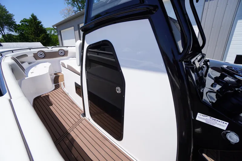Slide: The Image of 2024 Tidewater 320 CC Adventure boat interior with sleek design and wood flooring. - 42