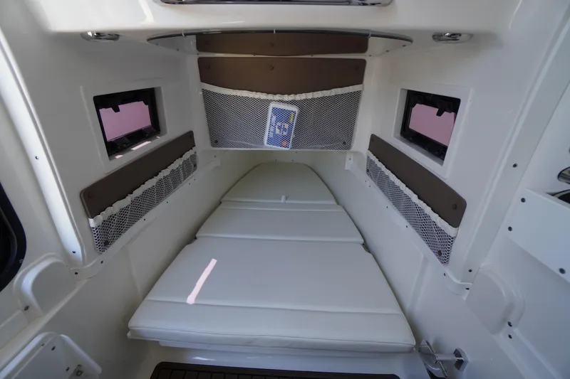 Slide: The Image of 2024 Tidewater 320 CC Adventure cabin interior with cushioned seating and storage nets. - 44