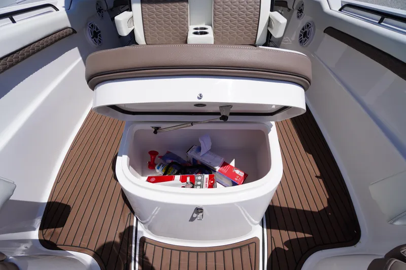 Slide: The Image of 2024 Tidewater 320 CC Adventure boat storage compartment with open lid and items inside. - 47