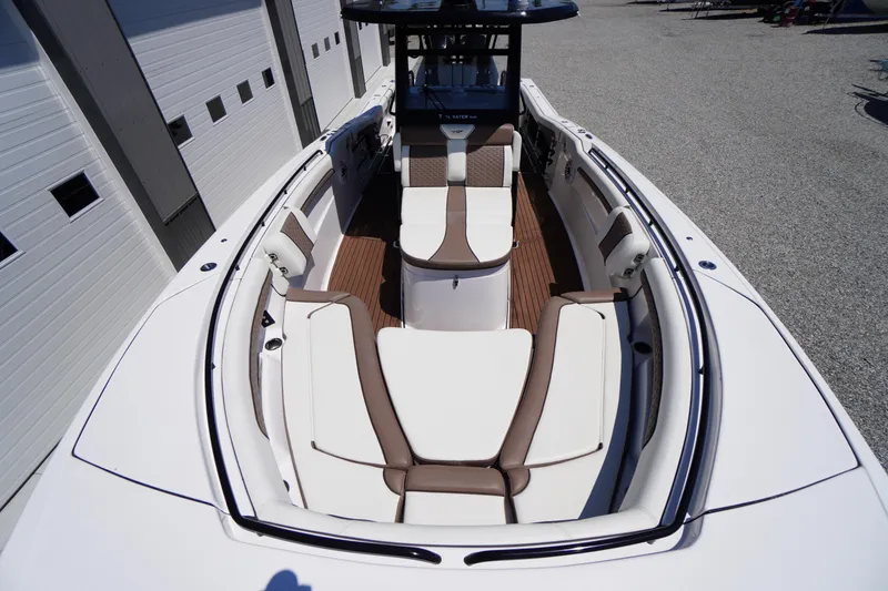 Slide: The Image of 2024 Tidewater 320 CC Adventure boat interior with white and brown seating. - 48