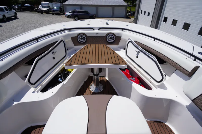 Slide: The Image of 2024 Tidewater 320 CC Adventure boat interior with wood accents and storage compartments. - 53