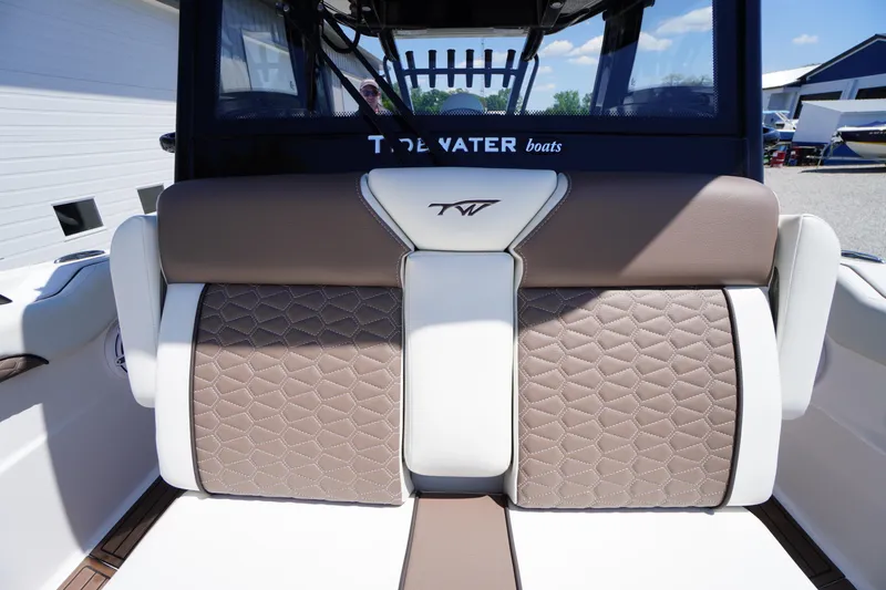Slide: The Image of 2024 Tidewater 320 CC Adventure boat seat with elegant brown and white upholstery. - 55