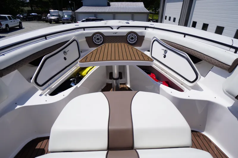 Slide: The Image of 2024 Tidewater 320 CC Adventure boat interior with seating, storage, and speakers. - 56