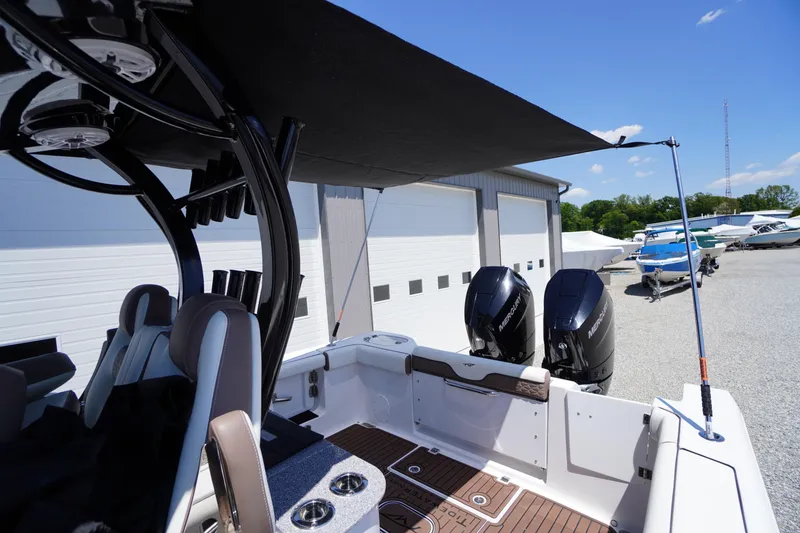 Slide: The Image of 2024 Tidewater 320 CC Adventure boat with dual Mercury engines and shaded deck area. - 62