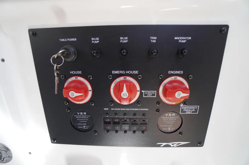 Slide: The Image of Control panel of 2024 Tidewater 320 CC Adventure boat with switches and key. - 65