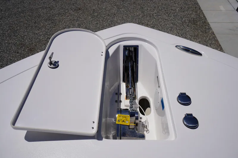 Slide: The Image of 2024 Tidewater 320 CC Adventure boat anchor compartment with open hatch. - 67
