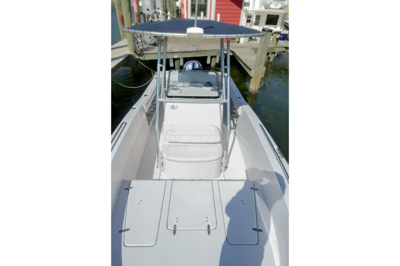 Slide: The Image of 2003 Grady-White Fisherman 222 boat docked, featuring a center console and T-top. - 2